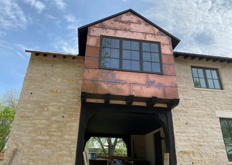 Copper metal panel facade on a stone building for Skylight Installation in Flowery Branch