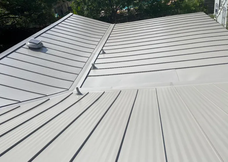 Solar attic fan installed on a metal roof for Roof Ventilation in Flowery Branch